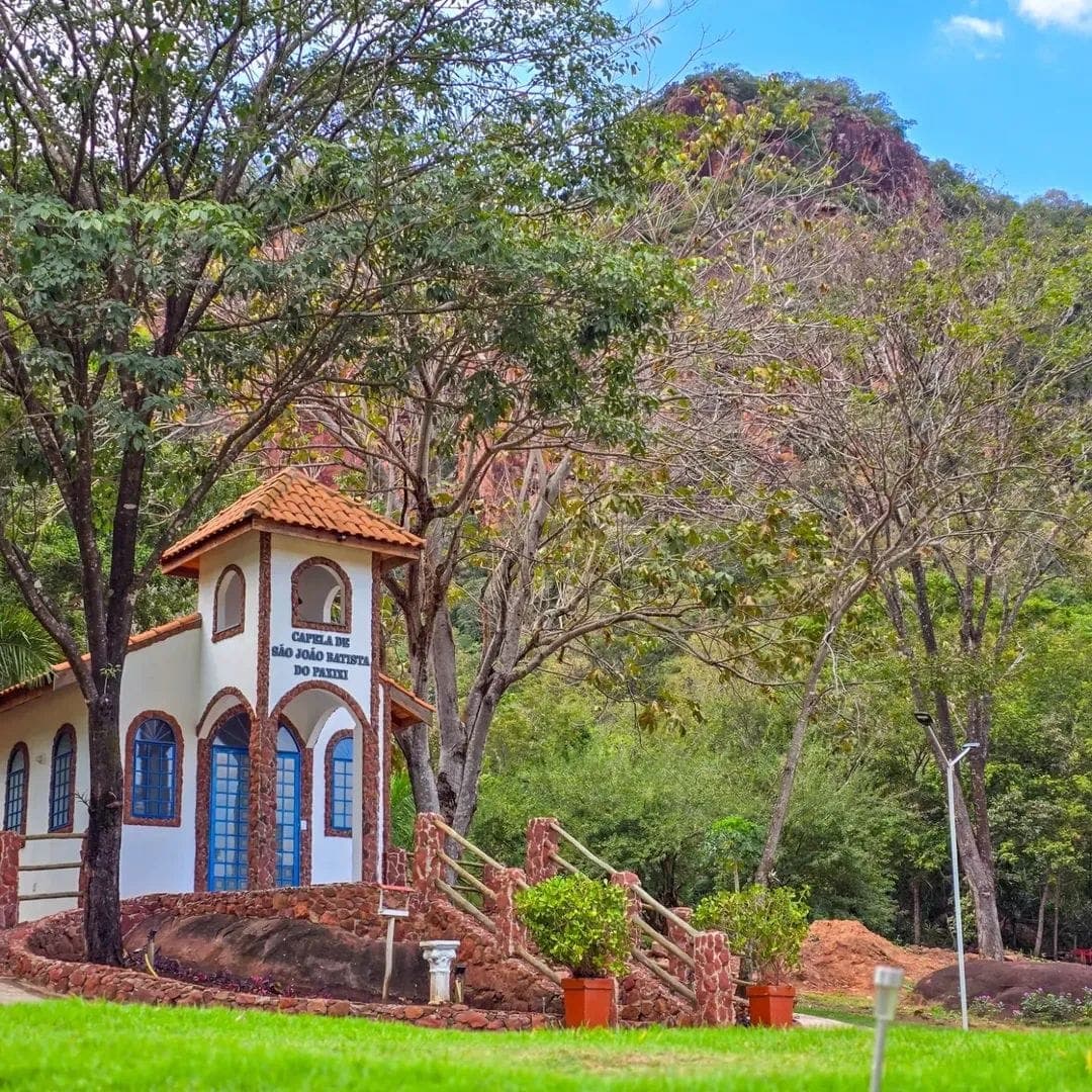 White chapel set into the hillside landscape.