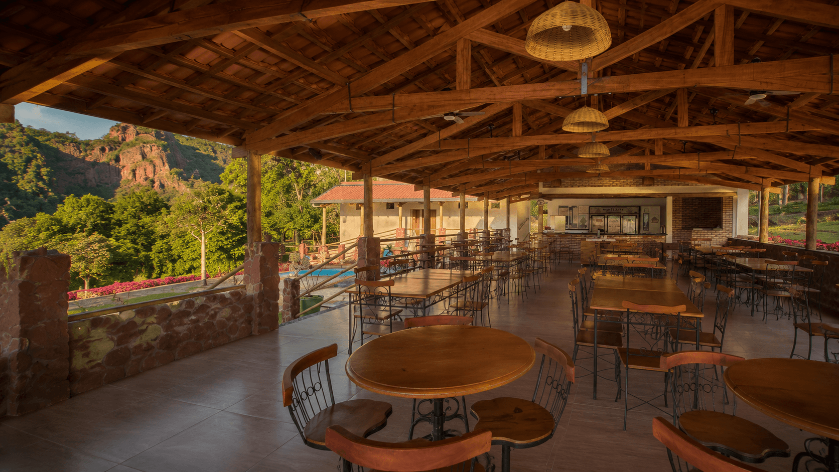 Wooden interior of the pousada with tables and a cozy setting for events.