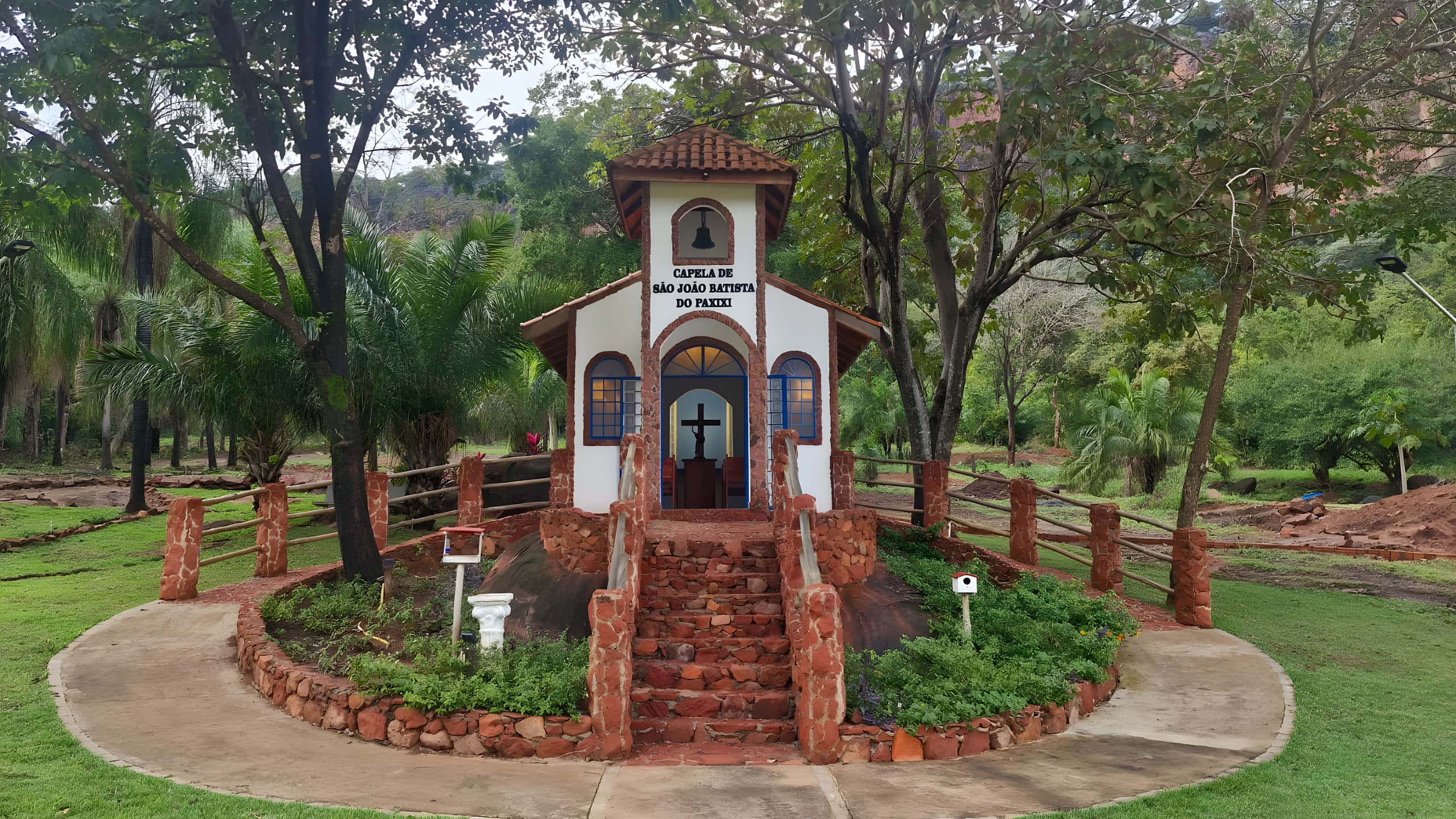 Capela São João Batista surrounded by the green hills.