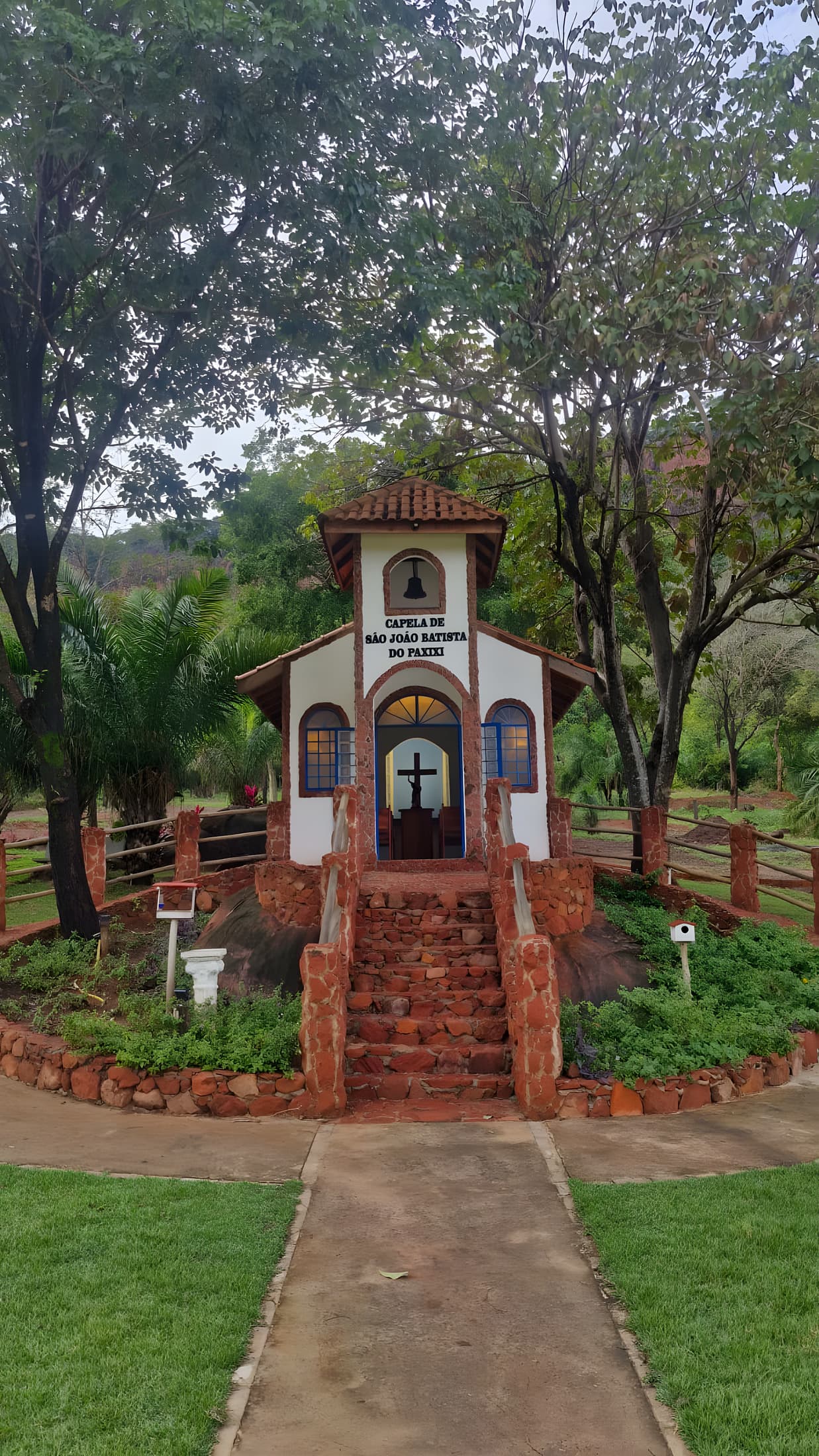 Capela São João Batista surrounded by the green hills.